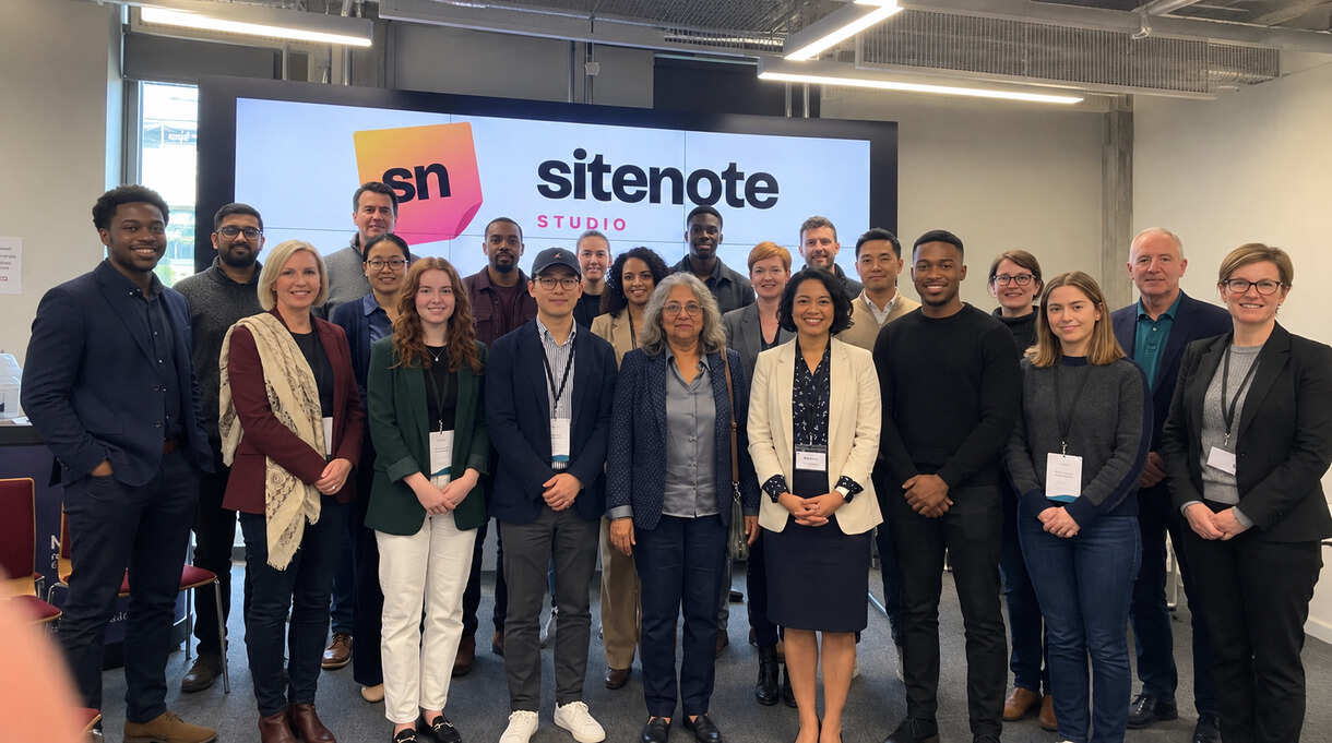 The Sitenote Studio team in front of the Sitenote logo